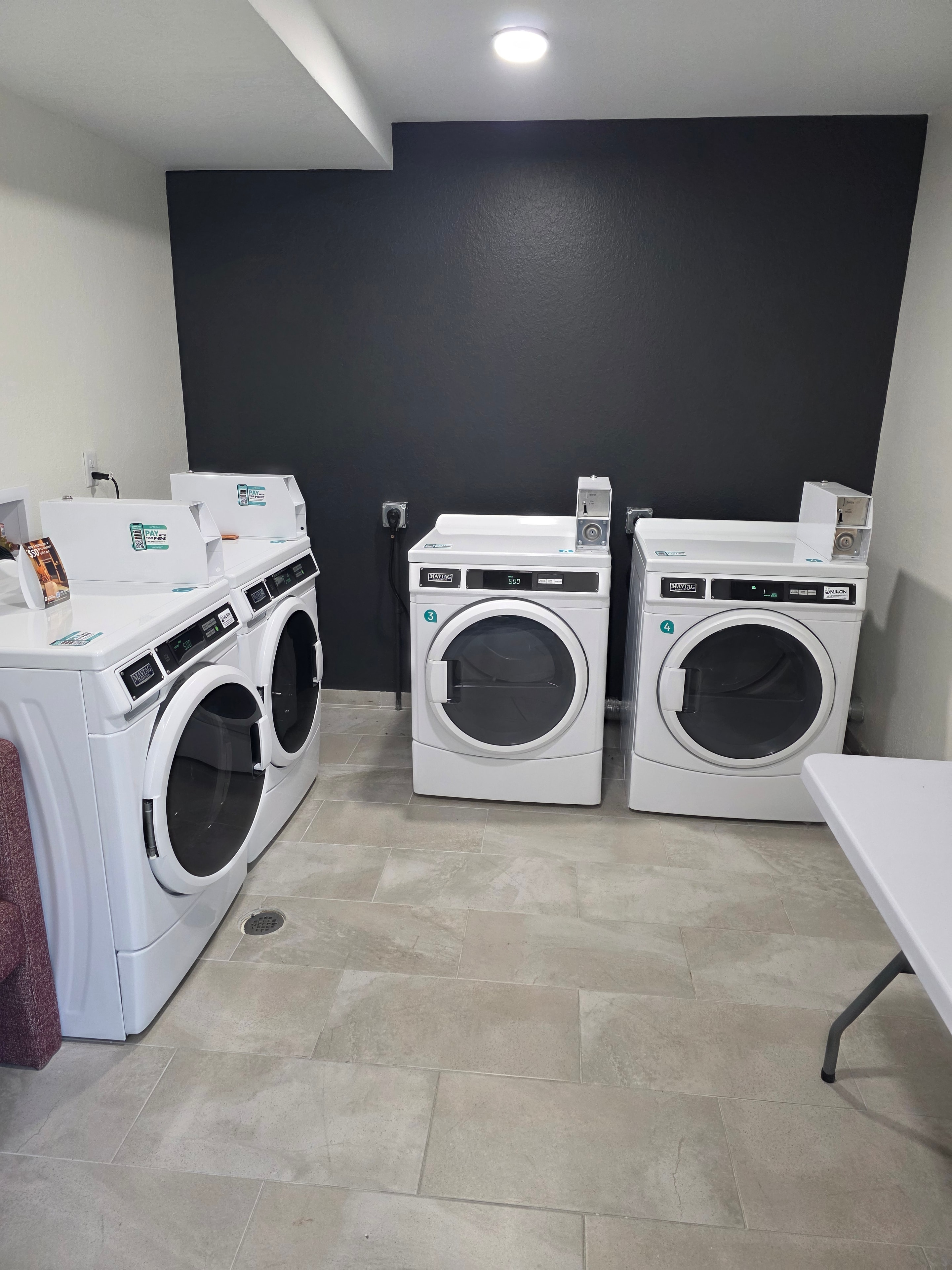 Commercial laundry room with dryers and washers
